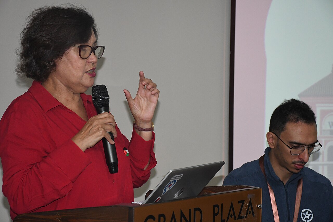 A speaker addressing an audience at a conference, showing communication skills in action