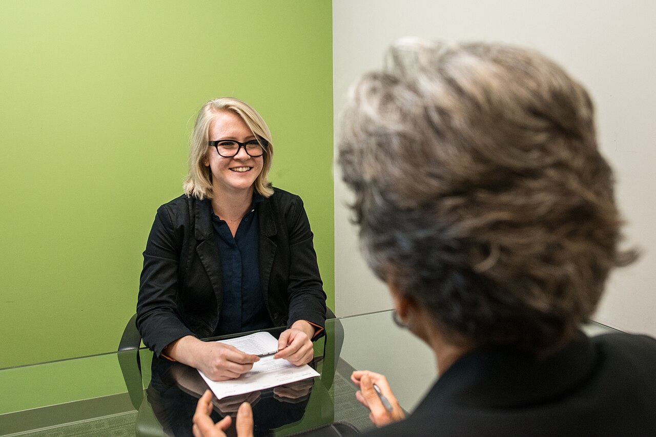 A smiling candidate answering questions at a job interview