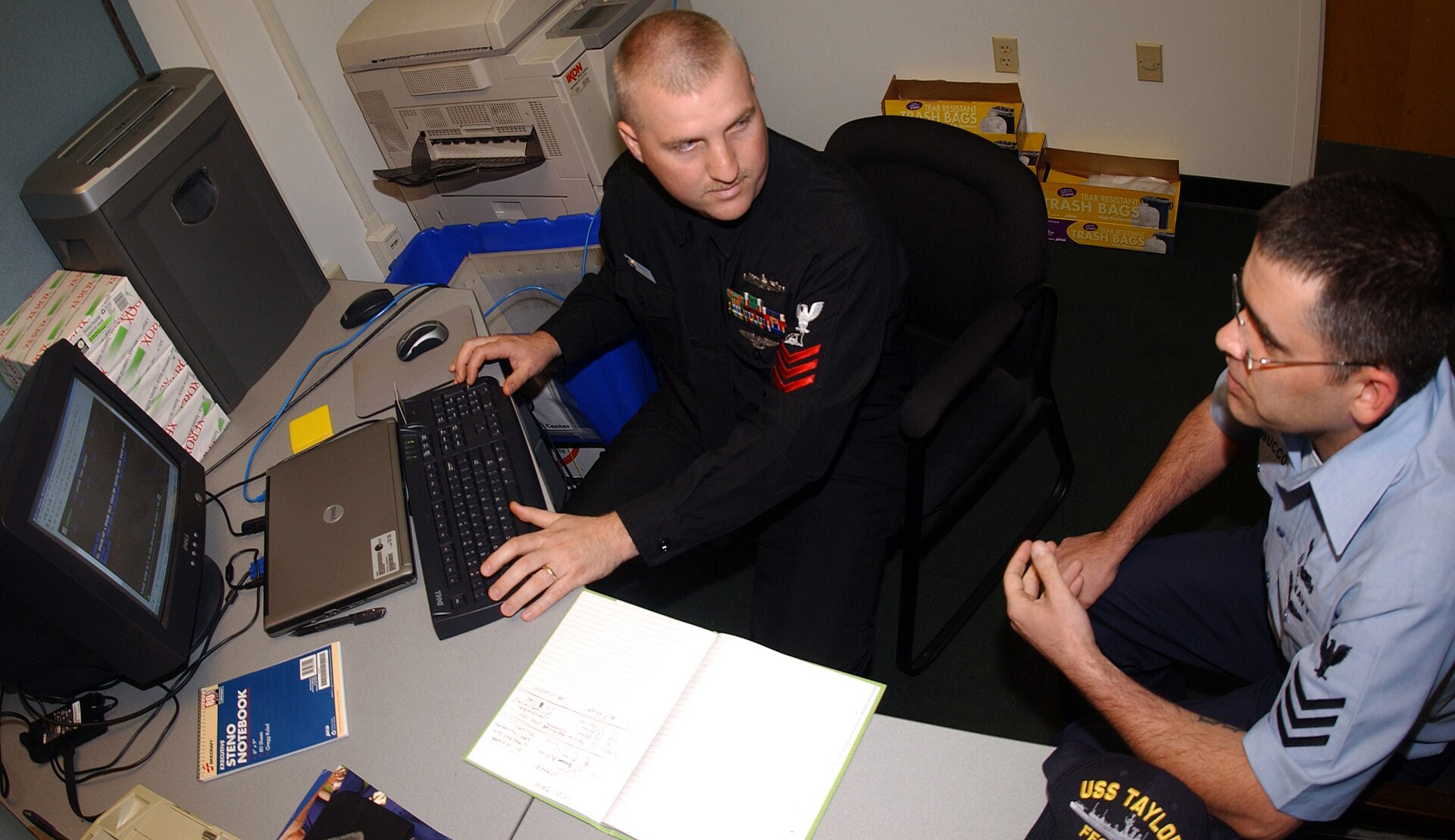 Two people discussing career plans at a desk with a computer