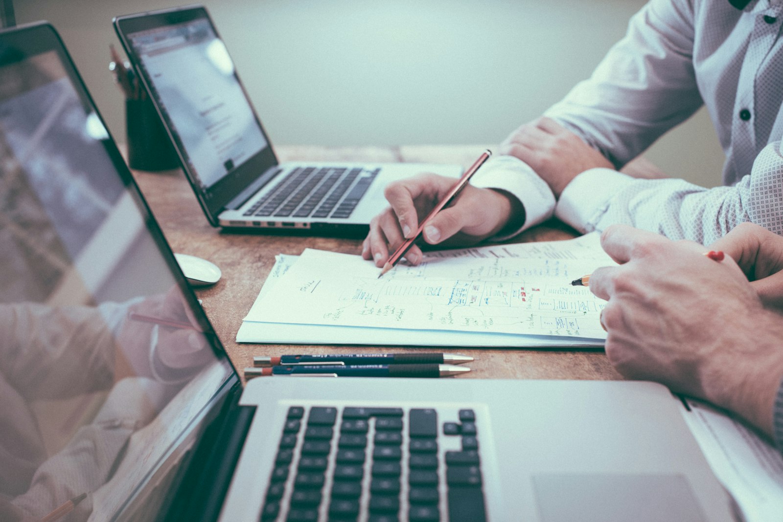Planning documents and a laptop used to prepare a career change resume