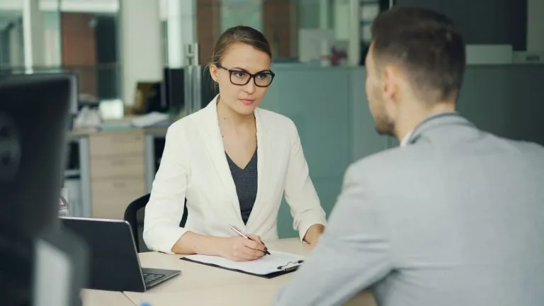 Young professional discussing how to negotiate salary for your first job with a hiring manager