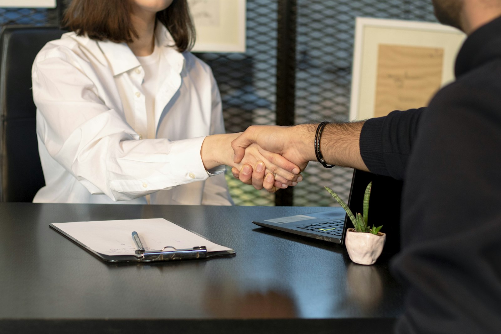 Shaking hands with a manager after reaching an agreement on a job offer