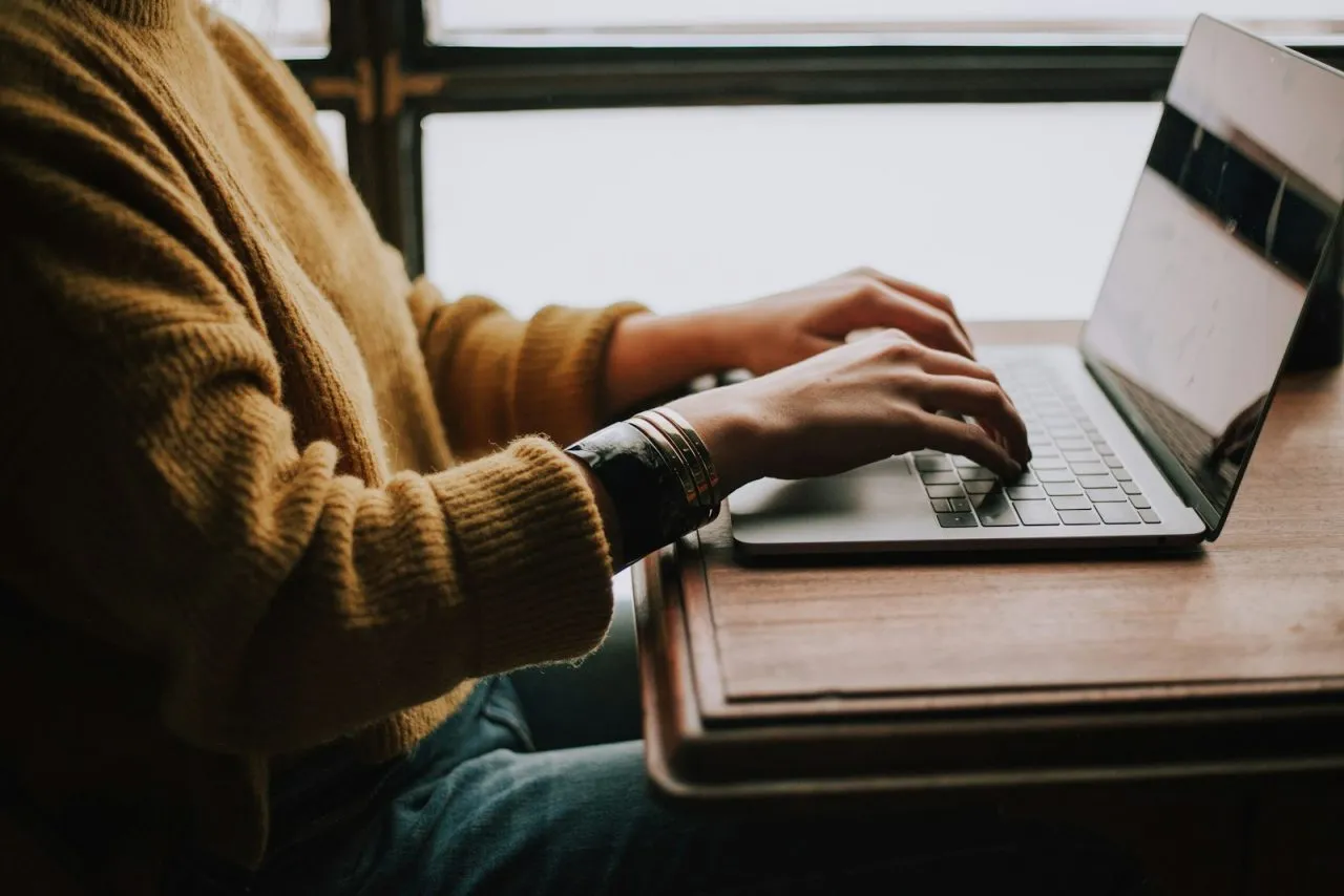 Student searching for internships and preparing an application on a laptop