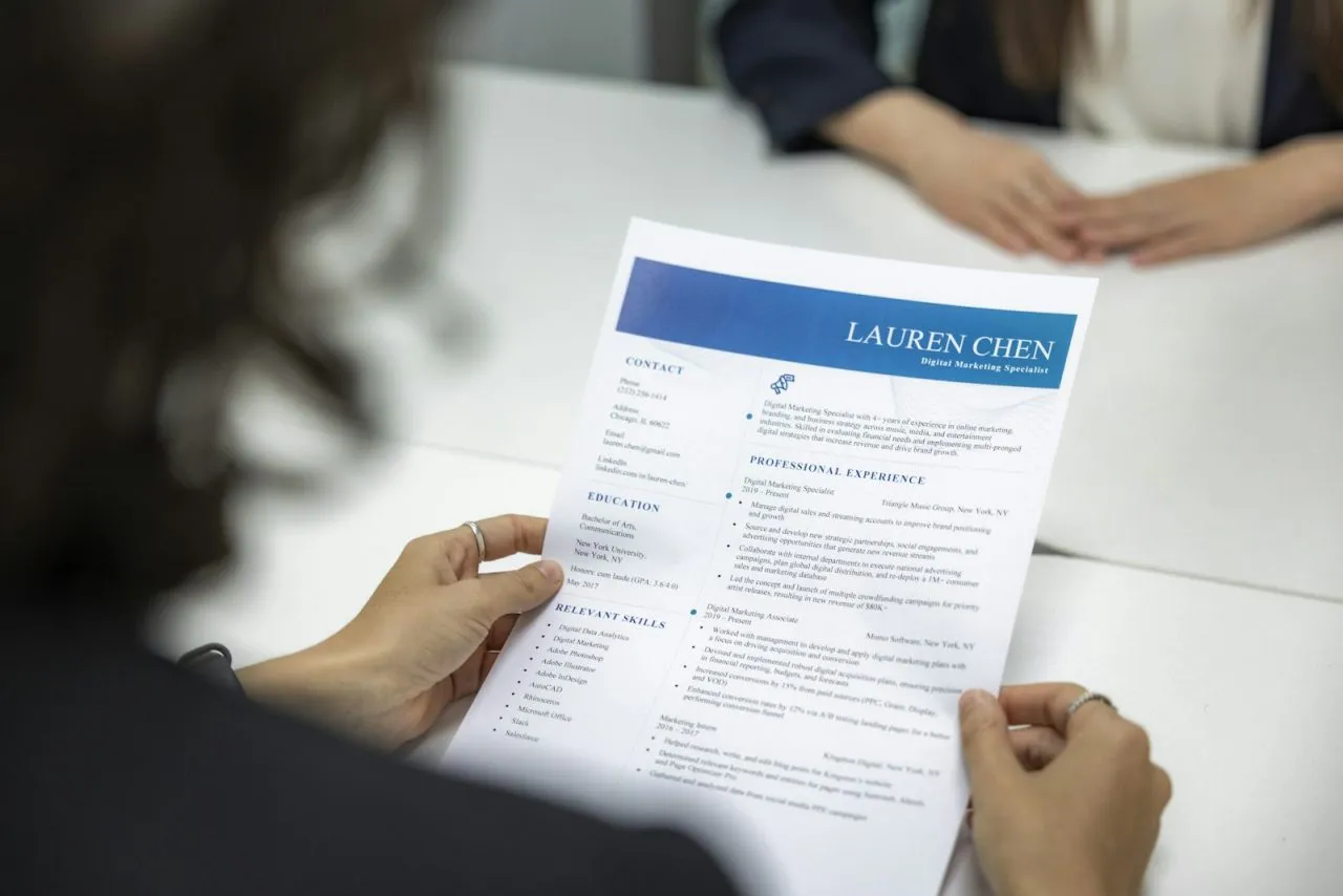 Hiring manager reading a printed resume during a job interview