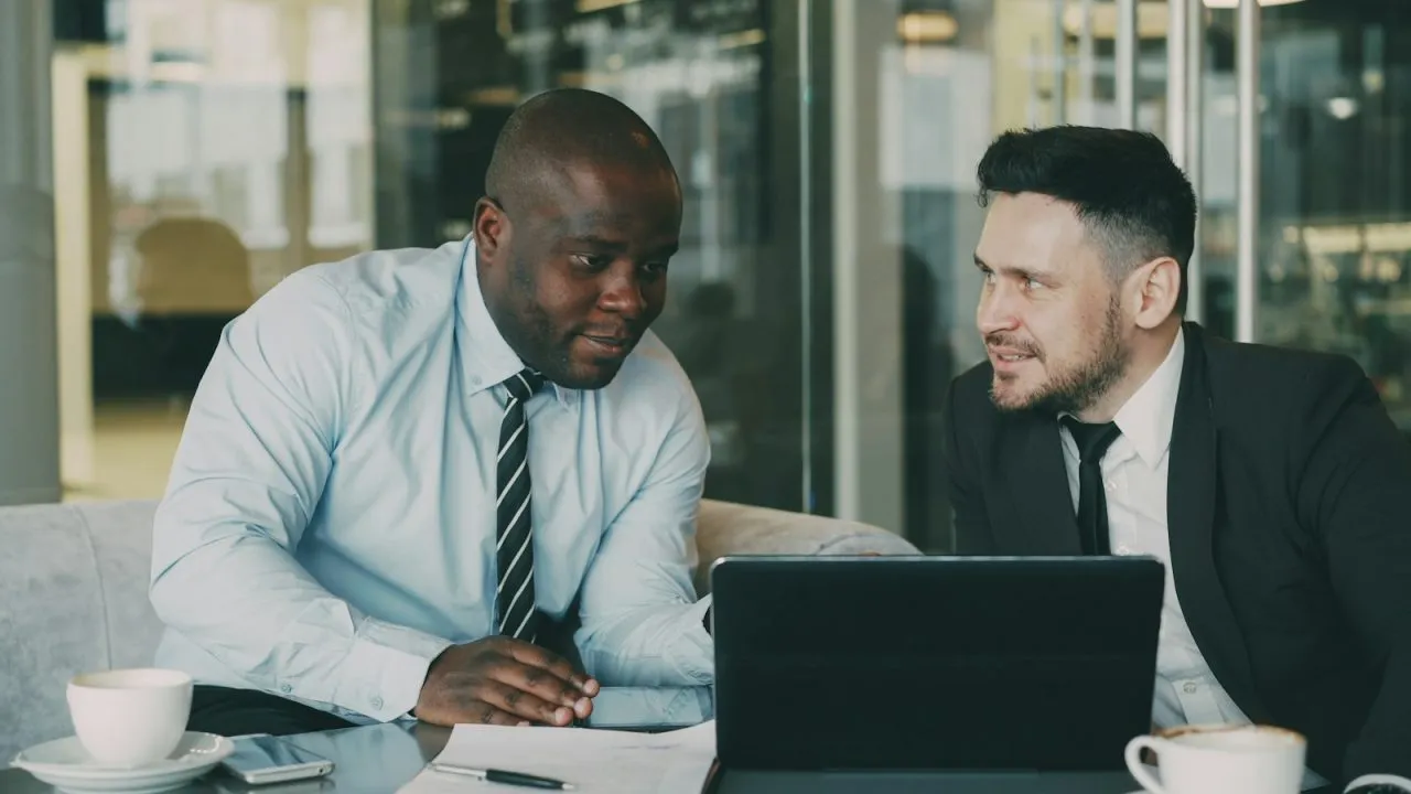 Two professionals calmly discussing a job offer at a desk during a salary negotiation