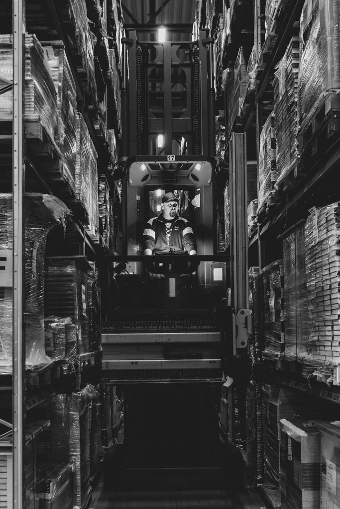 warehouse jobs — a forklift driver moving a pallet safely